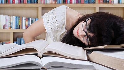girl-sleeping-on-books