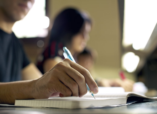 student-writing-in-book